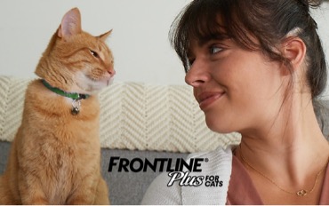 Woman and cat lovingly smile at each other 